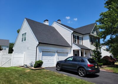 Roof Replacement by roofing contractor Freehold, NJ using GAF charcoal HDZ shingles and black seamless gutters.